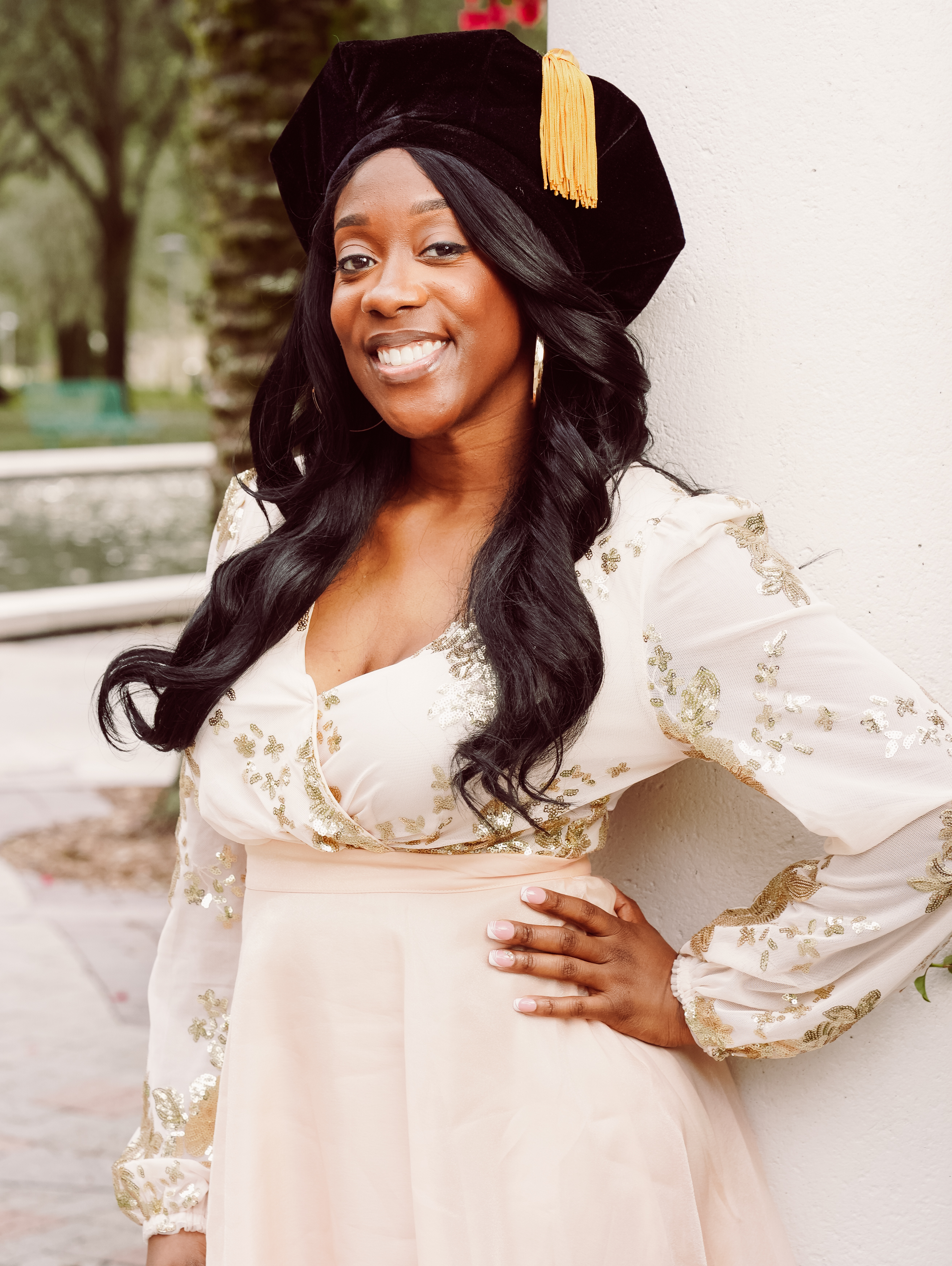 Portrait of Dr. Brittany Anthony wearing graduation regalia and smiling.